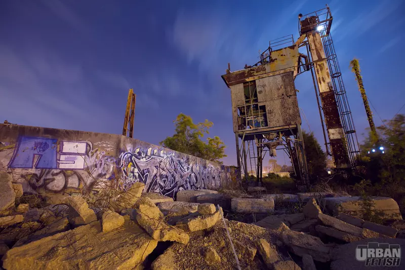 Cement factory at night on the wrong side of the tracks